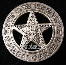 A heavily ornamented silver circle star badge with the word "Texas" in the center of the star and the word "Ranger" on the bottom of the circle.