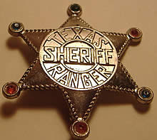 A bronze sheriff's shaped badge with the words "Texas Sheriff Ranger" on it.