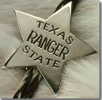 A silver star shaped badge with the words "Texas Ranger State" in the middle.