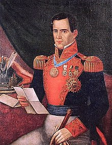 A painted portrait of a man in an elaborate military uniform seated looking at a letter with a sword in his lap.