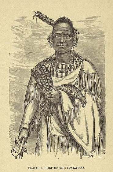 A Tonkawa man in fringed regalia holding a pipe, a dead bird, and a handful of feathers.