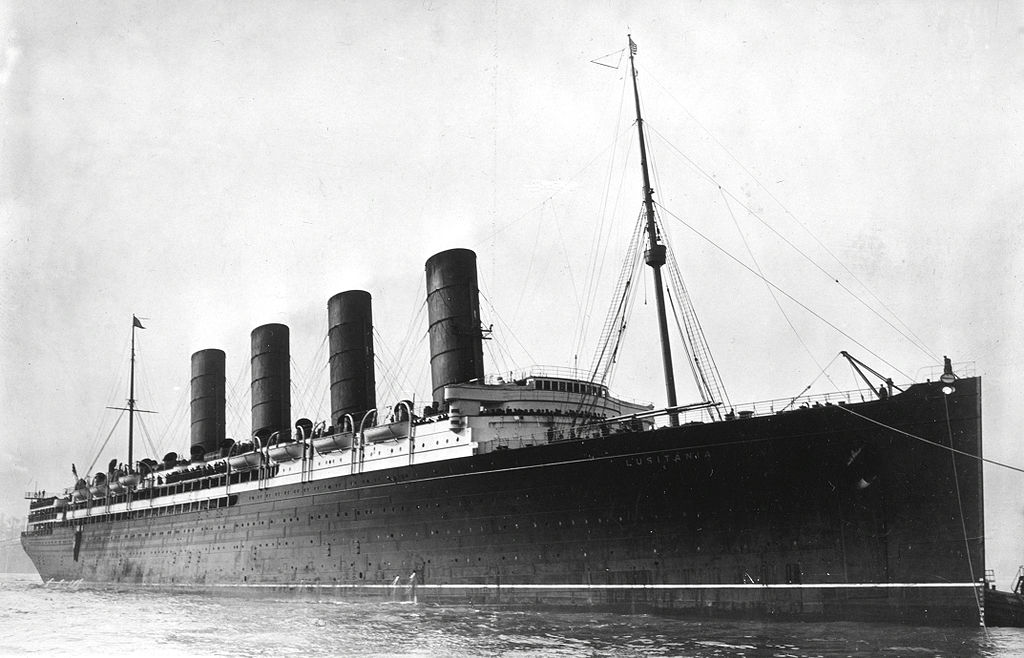 A large early 1900s steam ship with four large steam stacks.