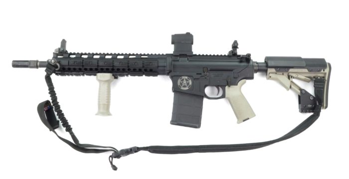 A grey assault rifle with cream tan accents and the Texas Ranger badge inscribed on it.