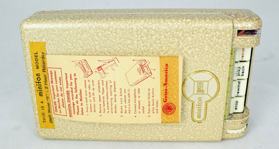 A speckled tan video recorder with instructions taped on the lid.