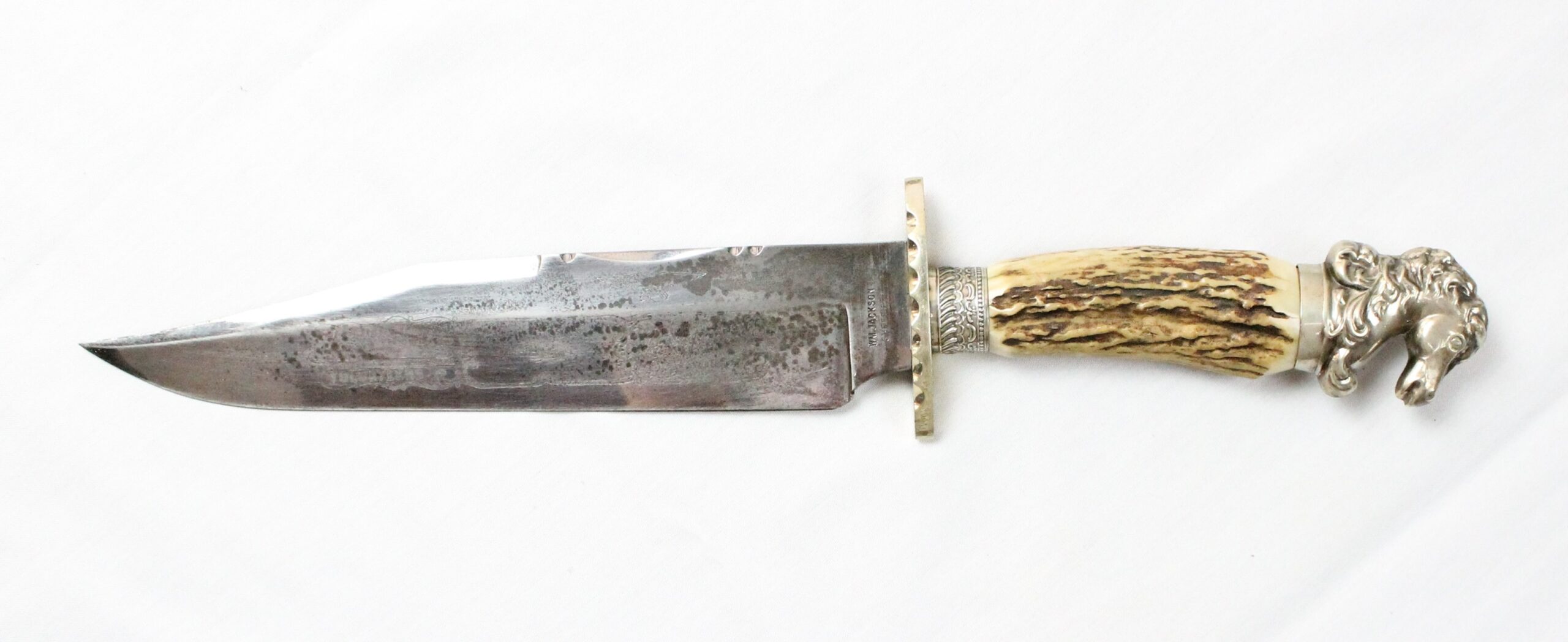 silver knife with horn handle topped with silver sculpted horse head